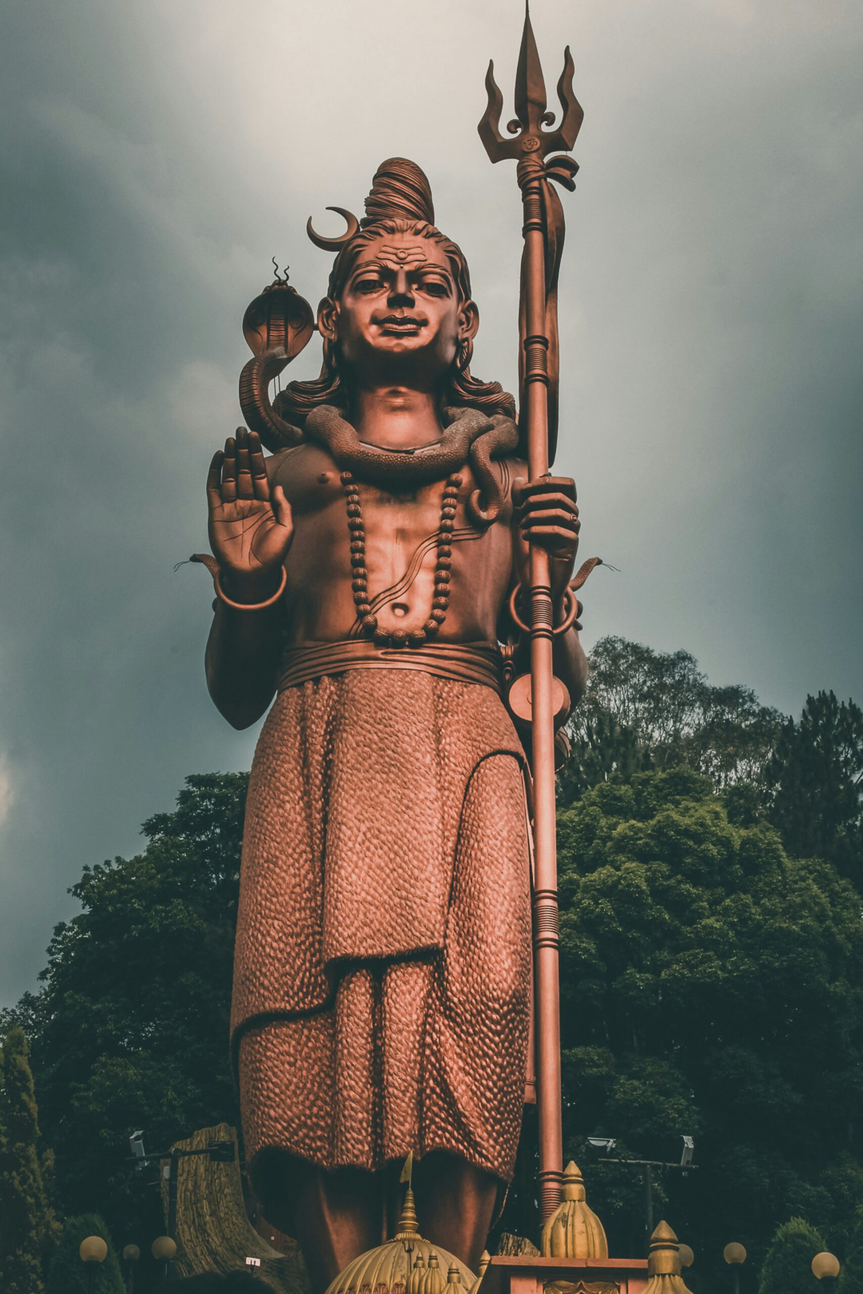 woman in orange and black dress statue